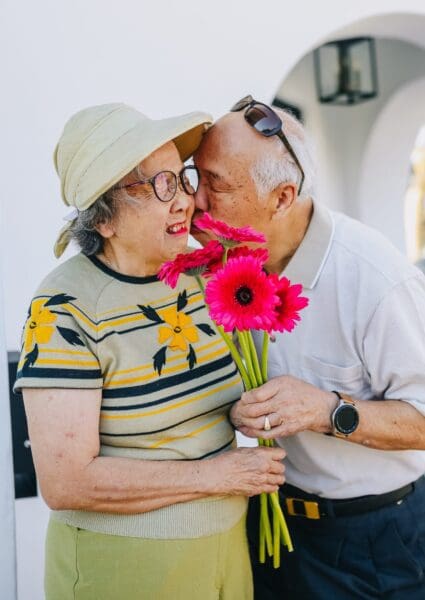 Couple kissing with flowers
