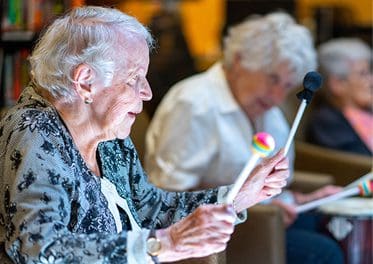 Older woman enjoying social gathering at the Mary Schwartz Summit in Seattle