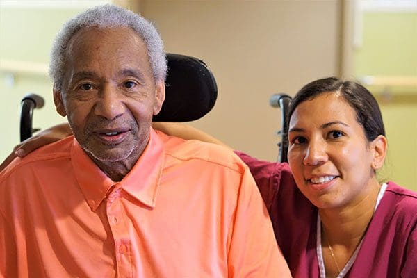 Nurse smiling with a memory care resident at Kline Galland Home in Seattle