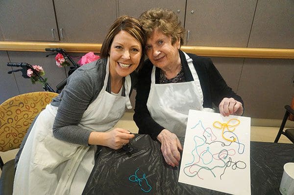 Women doing art projects during one of the art groups offered to memory support residents at The Mary Schwartz Summit in Seattle