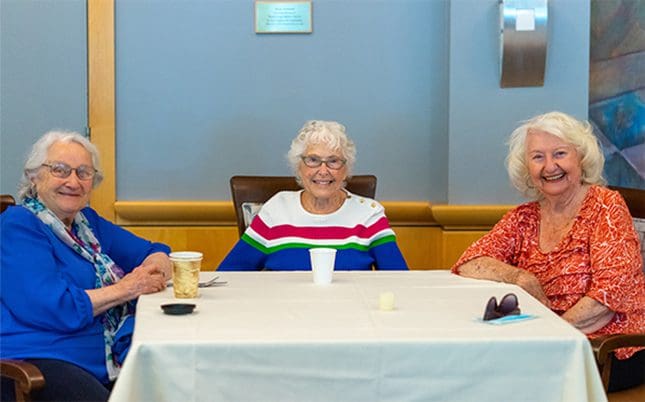 Group of smiling ladies enjoying the independent living options offered at the Mary Schwartz Summit in Seattle