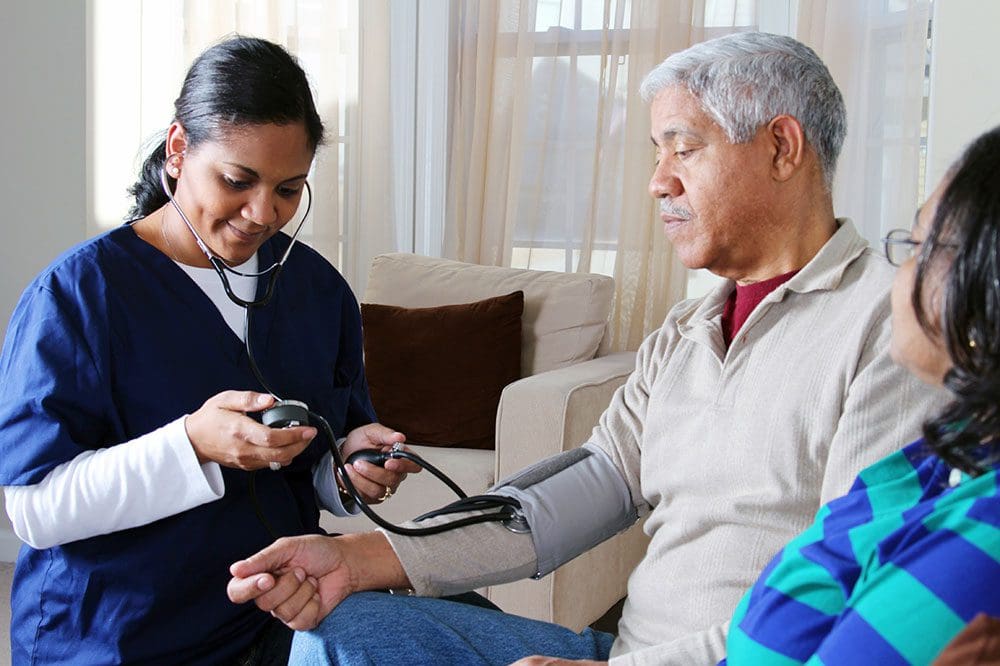 Nurse taking patient's blood pressure