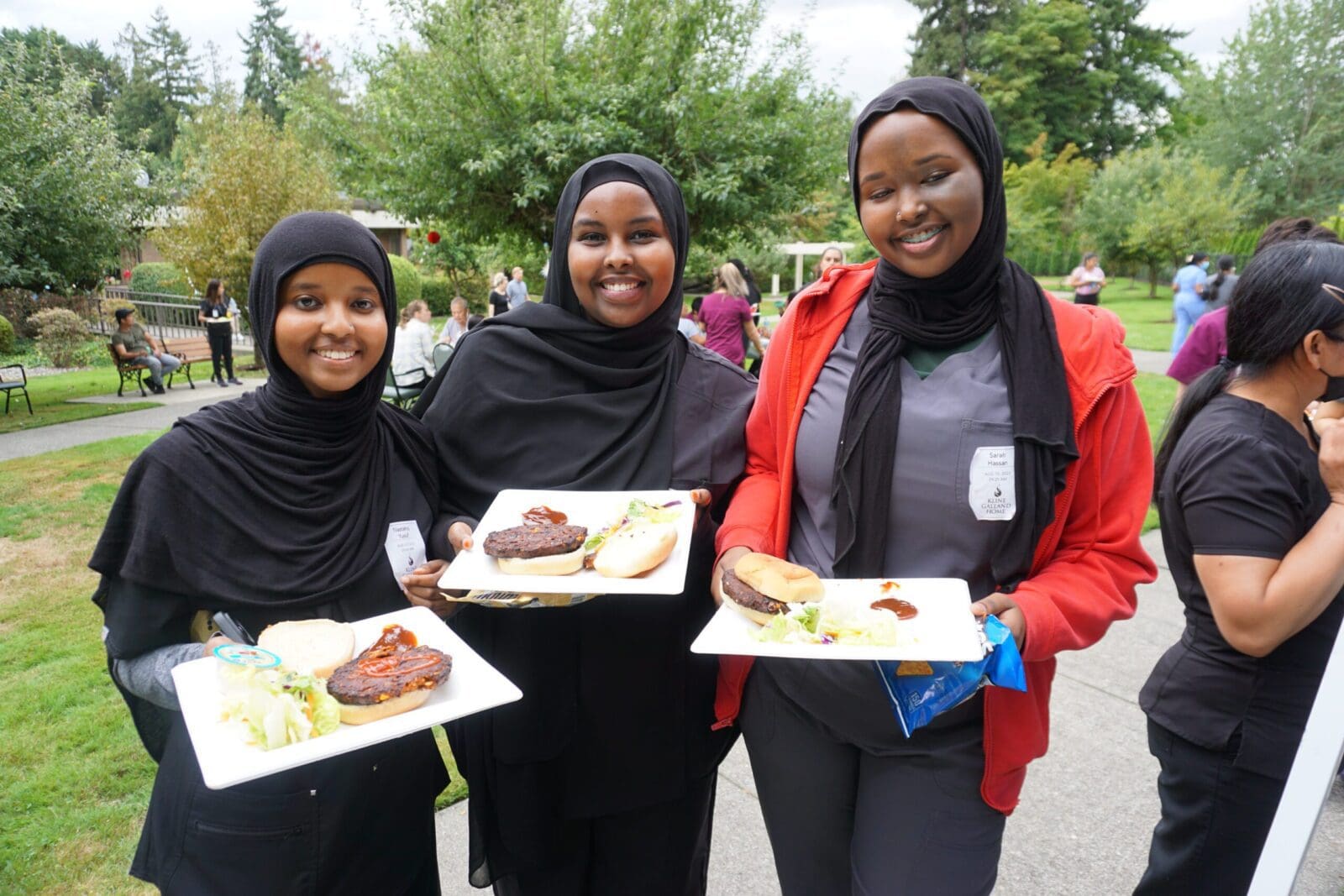 Kline Galland staff holds food outside