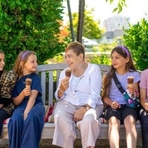 Woman eating ice cream with children