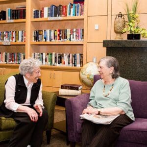 Friends laughing in  library at Mary Schwartz