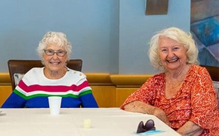 Group of smiling ladies enjoying the independent living options offered at the Mary Schwartz Summit in Seattle